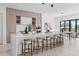 Open kitchen with stainless steel appliances, an island with barstool seating and an adjacent dining area at 1954 Iowa Ne Ave, St Petersburg, FL 33703