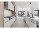 A long, elegant kitchen featuring modern appliances and plenty of counter space at 1954 Iowa Ne Ave, St Petersburg, FL 33703