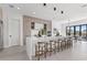 Open concept kitchen with an oversized island, light wood cabinets and black pendant lighting at 1954 Iowa Ne Ave, St Petersburg, FL 33703