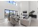 Modern living room features a fireplace, high ceilings, neutral color palette, and access to the patio at 1954 Iowa Ne Ave, St Petersburg, FL 33703
