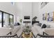 This expansive modern living room features high ceilings, a fireplace, stylish seating, and outdoor views at 1954 Iowa Ne Ave, St Petersburg, FL 33703