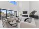 Bright living room features soaring ceilings, modern fireplace, comfortable seating, and access to the patio at 1954 Iowa Ne Ave, St Petersburg, FL 33703
