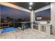 Outdoor kitchen and bar area with canal view at dusk at 1954 Iowa Ne Ave, St Petersburg, FL 33703