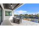 Covered patio with dining table overlooking canal and boat dock on a clear day at 1954 Iowa Ne Ave, St Petersburg, FL 33703