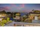 Waterfront view at dusk featuring a boat lift and lush tropical landscaping at 1954 Iowa Ne Ave, St Petersburg, FL 33703