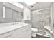 Updated bathroom featuring a marble surround shower with a seat and white cabinets at 200 Glennes Ln # 111, Dunedin, FL 34698
