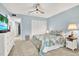 Bright bedroom with a comfortable bed, dresser, and access to a hallway at 200 Glennes Ln # 111, Dunedin, FL 34698