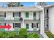 Charming condo featuring two stories with updated green doors and lovely landscaping at 200 Glennes Ln # 111, Dunedin, FL 34698