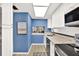 Well-lit kitchen with modern appliances, white cabinetry, and a pass-through view to the adjacent dining area at 200 Glennes Ln # 111, Dunedin, FL 34698