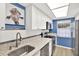 Well-lit kitchen with white cabinets, stainless steel appliances, and a charming giraffe portrait for added character at 200 Glennes Ln # 111, Dunedin, FL 34698