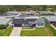 Aerial view of a house with solar panels, showcasing the property's position in a neighborhood with well-kept yards at 2132 Academy Dr, Clearwater, FL 33764