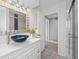 Stylish bathroom vanity with a modern sink, mirror, updated lighting and a glass enclosed shower at 2132 Academy Dr, Clearwater, FL 33764