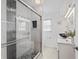 Bathroom featuring tile flooring, a walk-in shower with glass door, and a modern vanity at 2132 Academy Dr, Clearwater, FL 33764