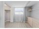 Bedroom closet with shelving, tile flooring, a window with curtains, and a dresser at 2132 Academy Dr, Clearwater, FL 33764
