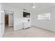 The bedroom features tile flooring, a ceiling fan, and a flat screen TV mounted above the dresser at 2132 Academy Dr, Clearwater, FL 33764