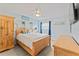 Bedroom features wood bed frame, white ceiling fan, and stylish decor at 2132 Academy Dr, Clearwater, FL 33764