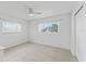 Bright bedroom featuring tile floors, two windows with blinds, and a ceiling fan at 2132 Academy Dr, Clearwater, FL 33764