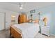 Charming bedroom with wood bed frame, surfboard, and stylish decor at 2132 Academy Dr, Clearwater, FL 33764