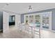 Bright dining area features pool views with white table and chairs at 2132 Academy Dr, Clearwater, FL 33764