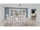 Dining room area with pool view features white table and chairs at 2132 Academy Dr, Clearwater, FL 33764