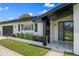 Charming home front with manicured landscaping, black accents and a welcoming entrance at 2132 Academy Dr, Clearwater, FL 33764