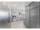 Bright kitchen with stainless appliances, light gray cabinetry, and hardwood-style floors at 2132 Academy Dr, Clearwater, FL 33764