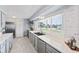 Bright kitchen features stainless appliances, light gray cabinetry, and hardwood-style floors at 2132 Academy Dr, Clearwater, FL 33764