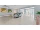 Open living room with tile flooring and views of the dining area and backyard pool at 2132 Academy Dr, Clearwater, FL 33764