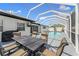 A backyard pool is complemented by a dining area and ample entertainment space at 2132 Academy Dr, Clearwater, FL 33764