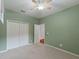 Bright bedroom with ceiling fan and double-door closet at 2622 Bonterra Blvd, Valrico, FL 33594