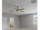 Main bedroom with ceiling fan and ensuite bathroom access at 2622 Bonterra Blvd, Valrico, FL 33594
