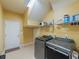 Laundry room with washer, dryer, and overhead storage at 2622 Bonterra Blvd, Valrico, FL 33594