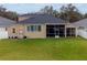 House back view with screened patio and fenced yard at 2622 Bonterra Blvd, Valrico, FL 33594
