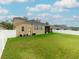 Back of house with large yard, screened patio, and AC units at 2622 Bonterra Blvd, Valrico, FL 33594