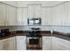 Kitchen features white cabinets, stainless steel appliances, and granite countertops at 2622 Bonterra Blvd, Valrico, FL 33594