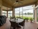 Relaxing screened patio with outdoor dining furniture and lake view at 2622 Bonterra Blvd, Valrico, FL 33594