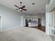 Open concept living room with views of kitchen and access to patio at 2622 Bonterra Blvd, Valrico, FL 33594