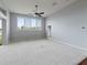 Spacious living room with carpeted floors and large windows at 2622 Bonterra Blvd, Valrico, FL 33594