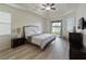 Main bedroom with wood-look floors and access to backyard at 2622 Bonterra Blvd, Valrico, FL 33594