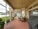 Relaxing screened patio with seating area, ceiling fan, and grill at 2622 Bonterra Blvd, Valrico, FL 33594