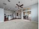 Open living room with kitchen views, carpeting, and access to patio at 2622 Bonterra Blvd, Valrico, FL 33594