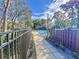 Walkway to community pool area with fences on each side at 2920 Star Apple Ct, Palm Harbor, FL 34684