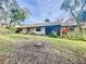 Home's backyard with grassy area and AC units at 2920 Star Apple Ct, Palm Harbor, FL 34684