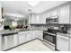 Modern kitchen with stainless steel appliances and granite countertops at 2920 Star Apple Ct, Palm Harbor, FL 34684