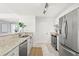 Galley-style kitchen with white cabinetry, granite countertops, stainless steel appliances, and bar seating at 345 Bayshore Blvd # 1104, Tampa, FL 33606