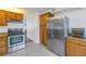 Kitchen features wood cabinets and stainless steel appliances at 4715 Bay Ne St # 227, St Petersburg, FL 33703