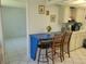 Bright kitchen features a breakfast bar, microwave, and view into adjacent dining area at 4915 Bay Ne St # 122, St Petersburg, FL 33703