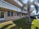 Condo building exterior, featuring landscaped grounds and balcony at 4915 Bay Ne St # 122, St Petersburg, FL 33703