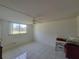 Bedroom with ceiling fan, window with a view, and tiled floor at 4915 Bay Ne St # 122, St Petersburg, FL 33703