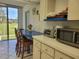 Kitchen with breakfast bar, microwave, and sliding glass doors to the patio at 4915 Bay Ne St # 122, St Petersburg, FL 33703